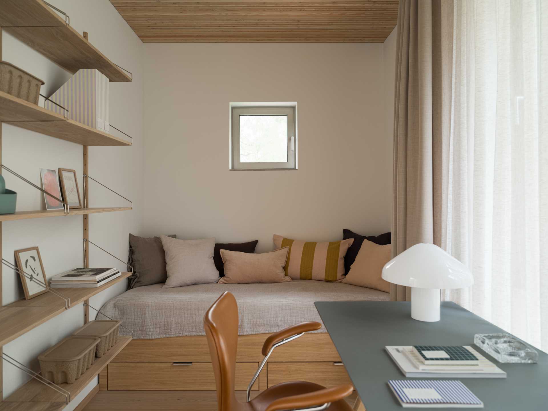 A modern bedroom with a desk and shelving.